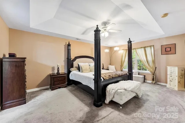 a bedroom with furniture and a large window