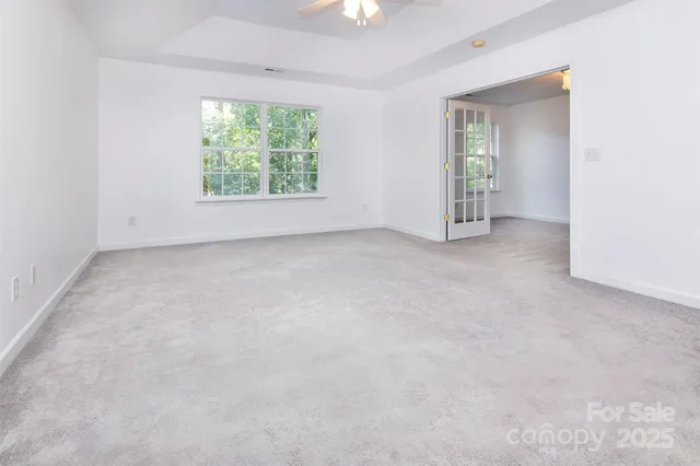 an empty room with windows and closet