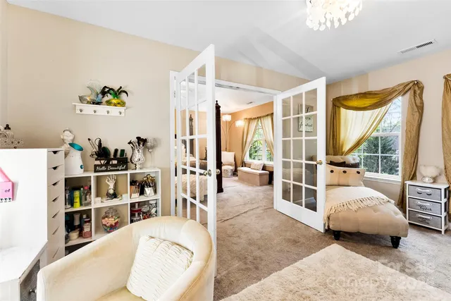 a bedroom with furniture and a large window