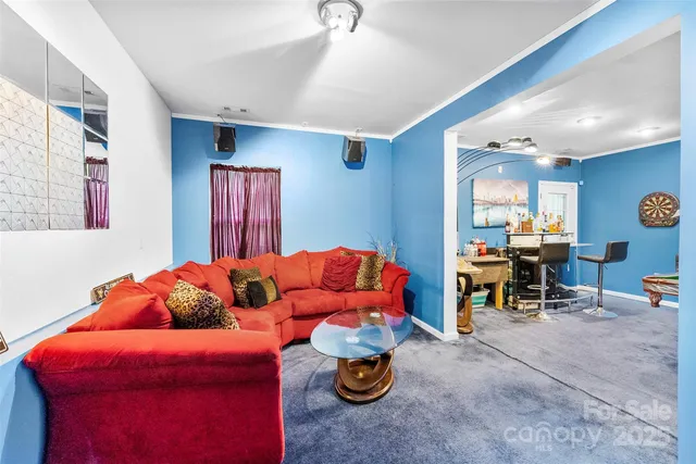 a living room with furniture and a mirror