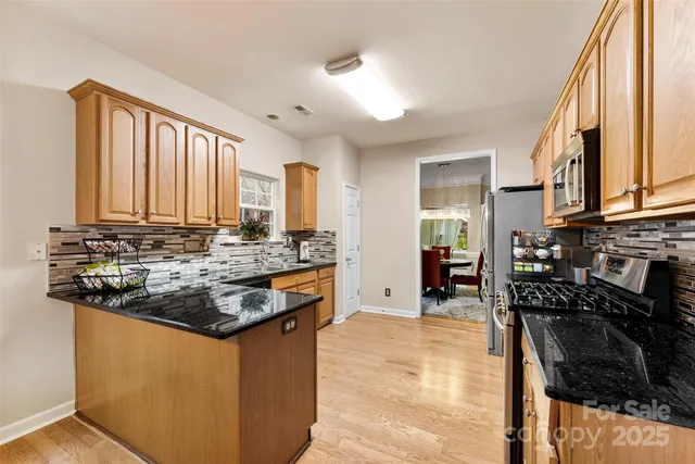 a kitchen with granite countertop a sink and a stove