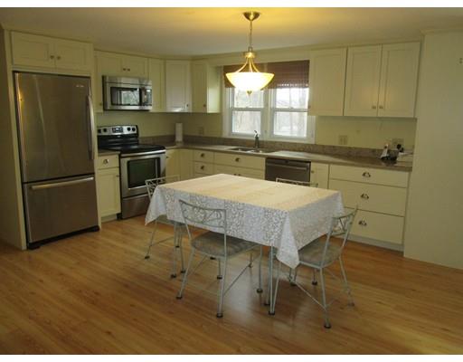 23 Tanner Road Webster, MA 01570 - Photo 6 of 30 a kitchen with stainless steel appliances granite countertop a sink a stove a refrigerator and island with wooden floor