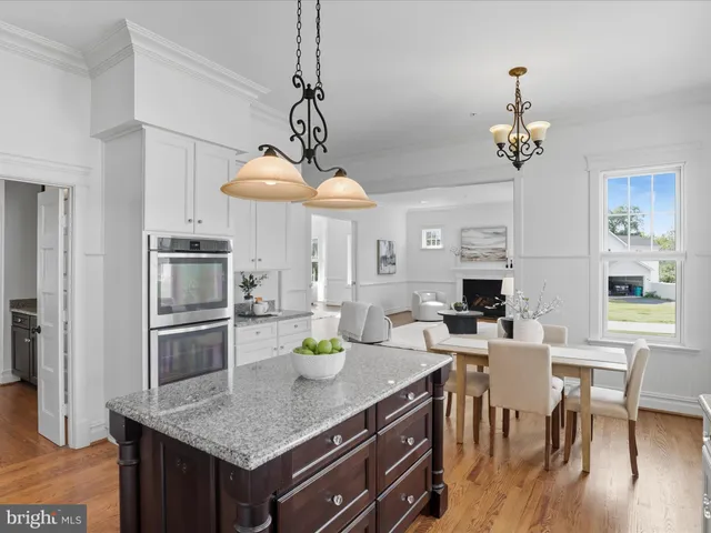 a living room with fireplace furniture and a potted plant