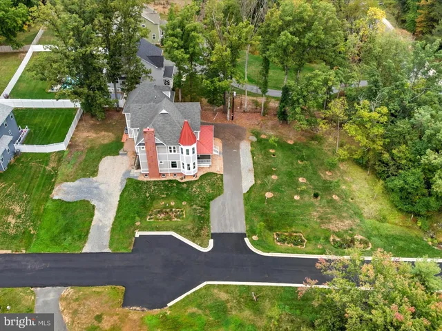 a view of a dining room with furniture a chandelier and wooden floor