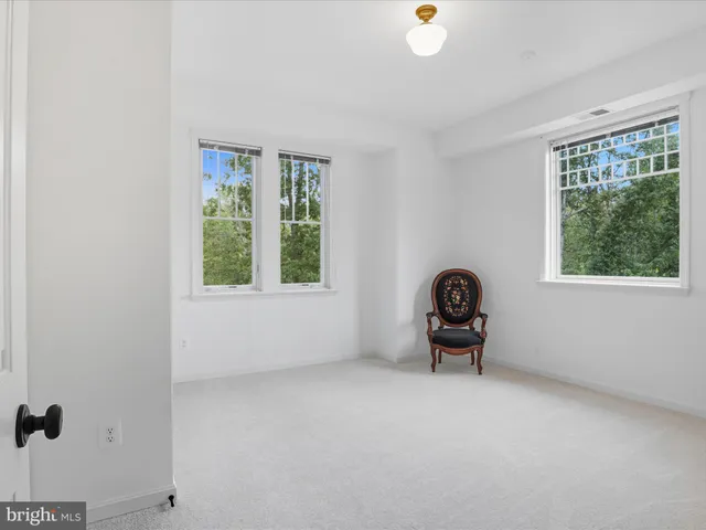a view of a kitchen with a refrigerator wooden cabinets and a sink