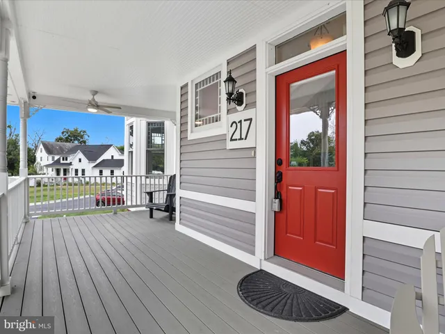a view of a dining room with furniture a chandelier and wooden floor