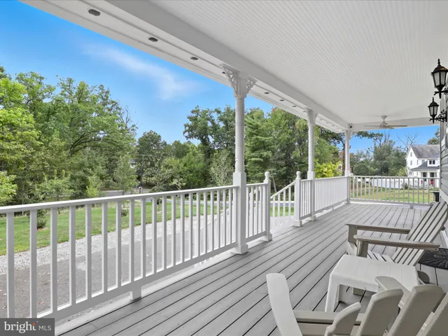 a dining room with wooden floor and chandelier
