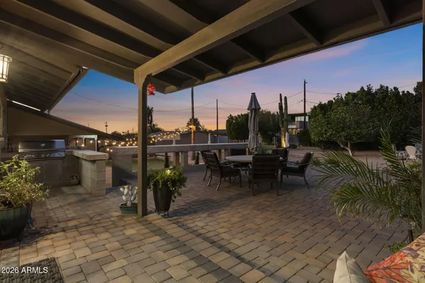 a view of a chairs and table in patio
