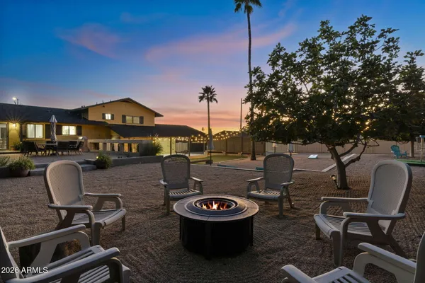 a view of a patio with table and chairs and potted plants