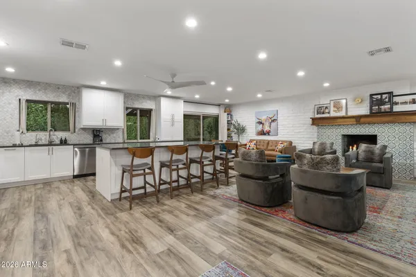 a living room with furniture and kitchen view