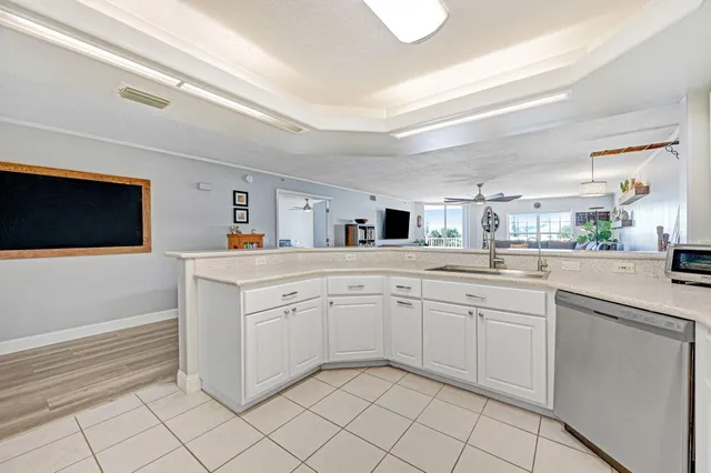 a spacious bedroom with a bed a flat screen tv and a fireplace