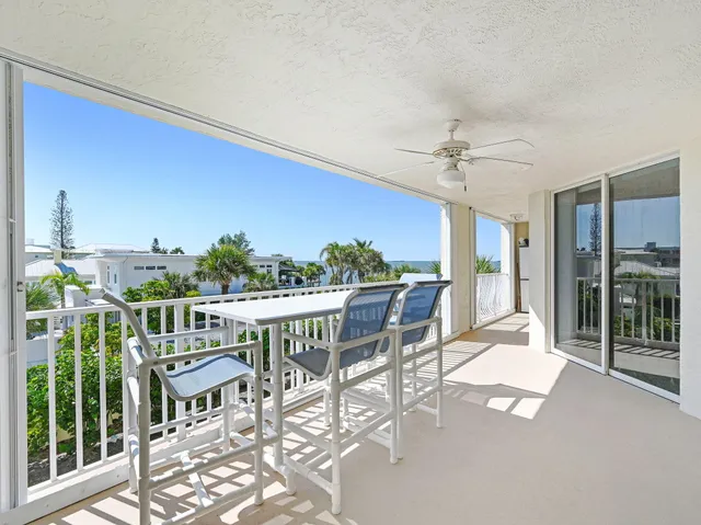a view of backyard with swimming pool and outdoor seating