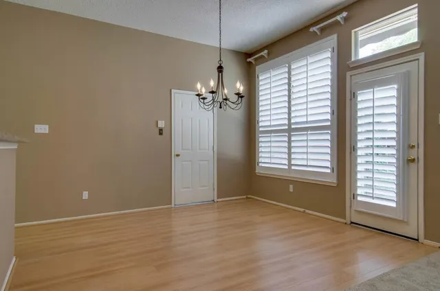 a view of a room with window and hardwood floor