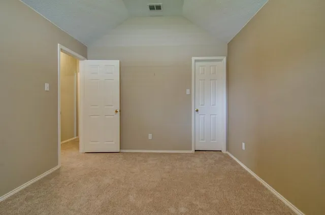 an empty room with closet area