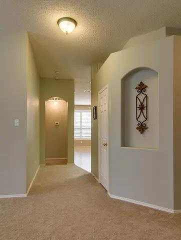an empty room with closet and mirror