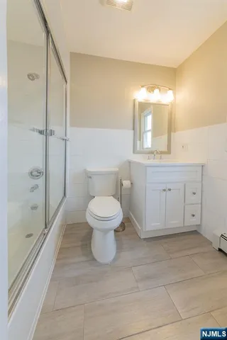 a bathroom with a toilet a sink and shower