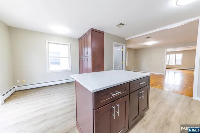 a kitchen with a stove and a wooden floor