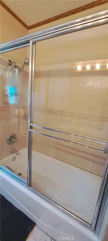 a bathroom with a bathtub and shower