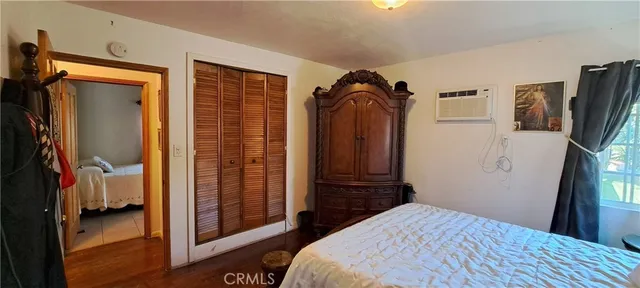 a bedroom with a bed and a mirror