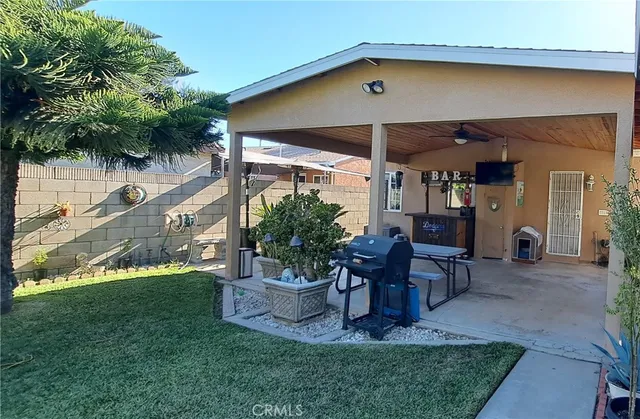 a view of a chair and table in backyard of the house