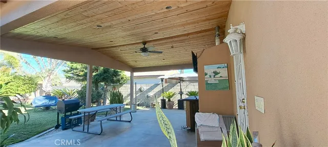 a view of a porch with chairs and backyard