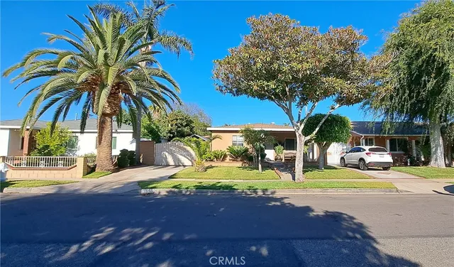 a view of a street with houses on the side