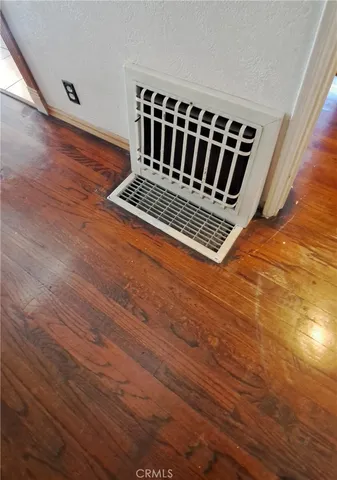 a view of a room with wooden floor