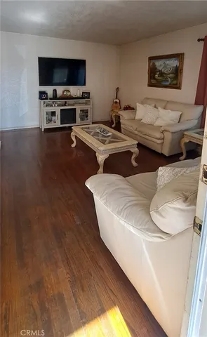 a living room with couches and a flat screen tv