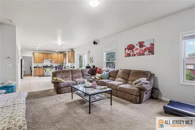 a bed sitting in a spacious bedroom next to a window