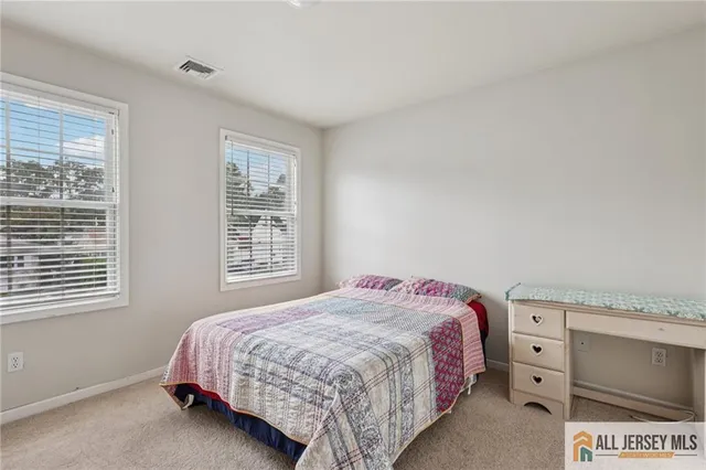 a bedroom with a bed and a table in it