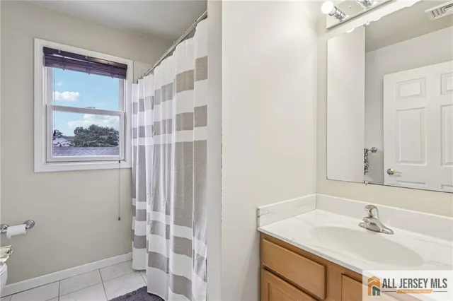 a front view of a house with a garden and chairs