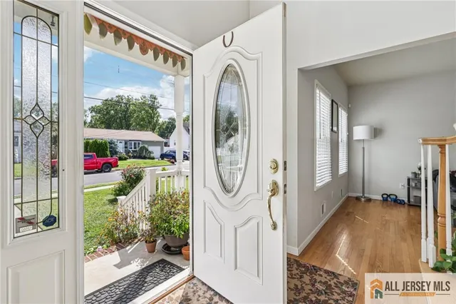 a view of a hallway with wooden floor and entryway