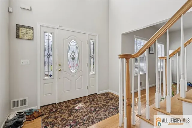 a living room with furniture and paintings on the wall