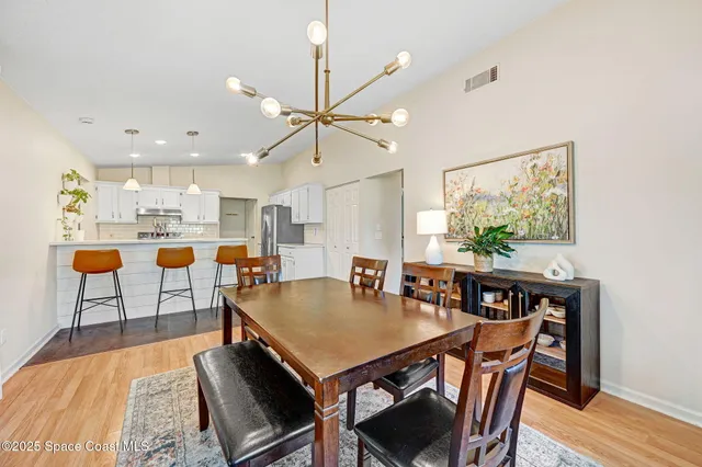 a living room with dining table and wooden floor