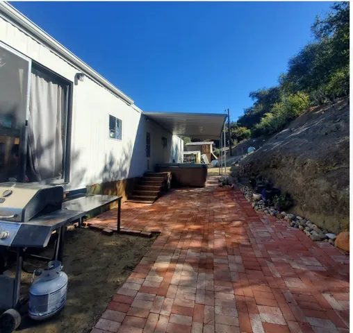 a backyard of a house with yard fire pit and outdoor seating