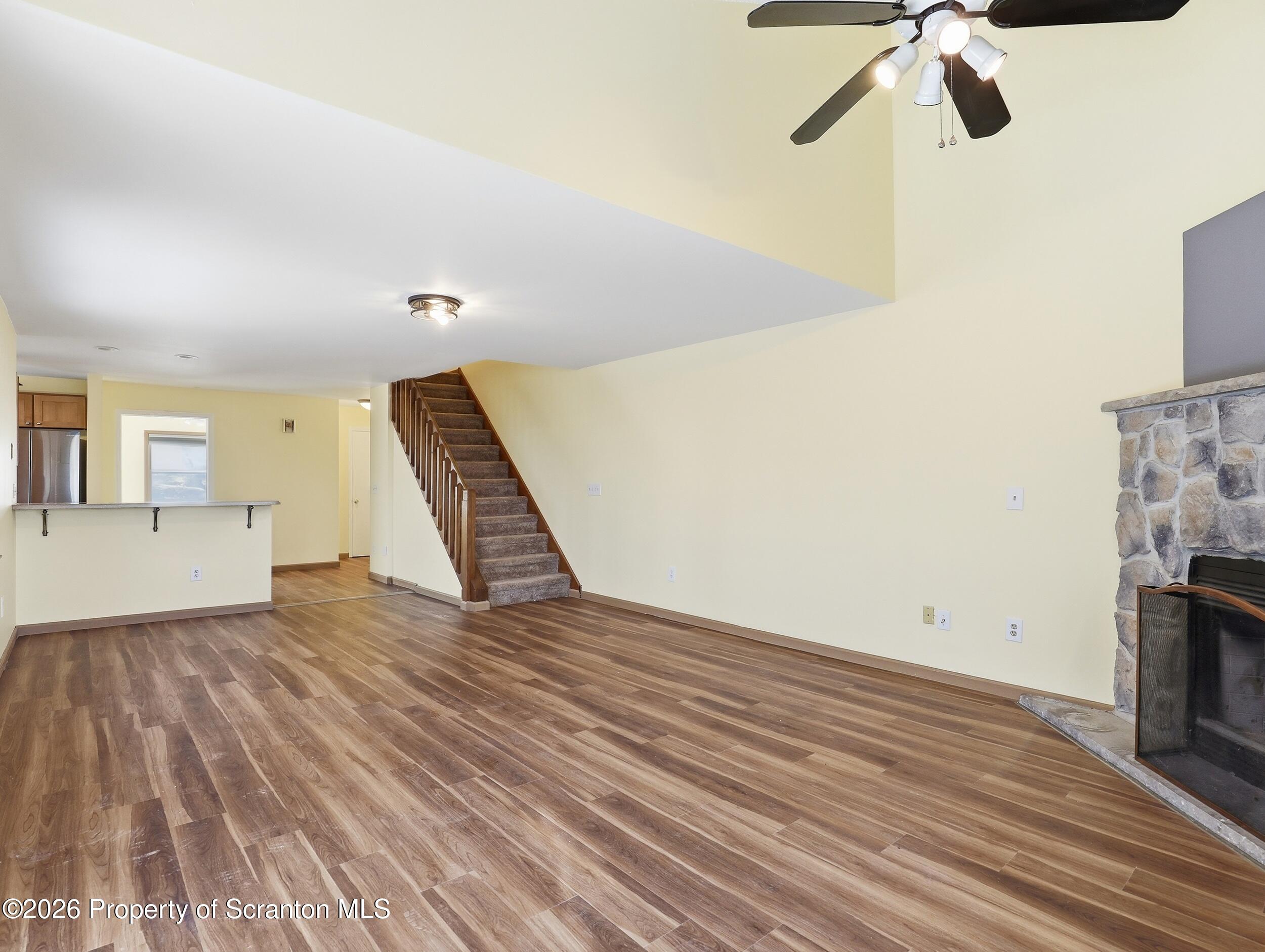 227 Image Drive Scotrun, PA 18355 - Photo 11 of 29 a view of an empty room with wooden floor and a fireplace