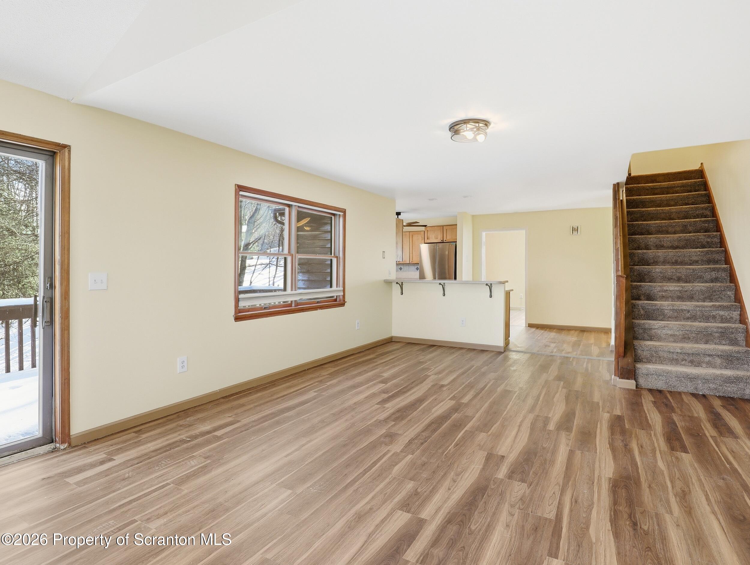 227 Image Drive Scotrun, PA 18355 - Photo 12 of 29 a view of empty room with wooden floor and fan