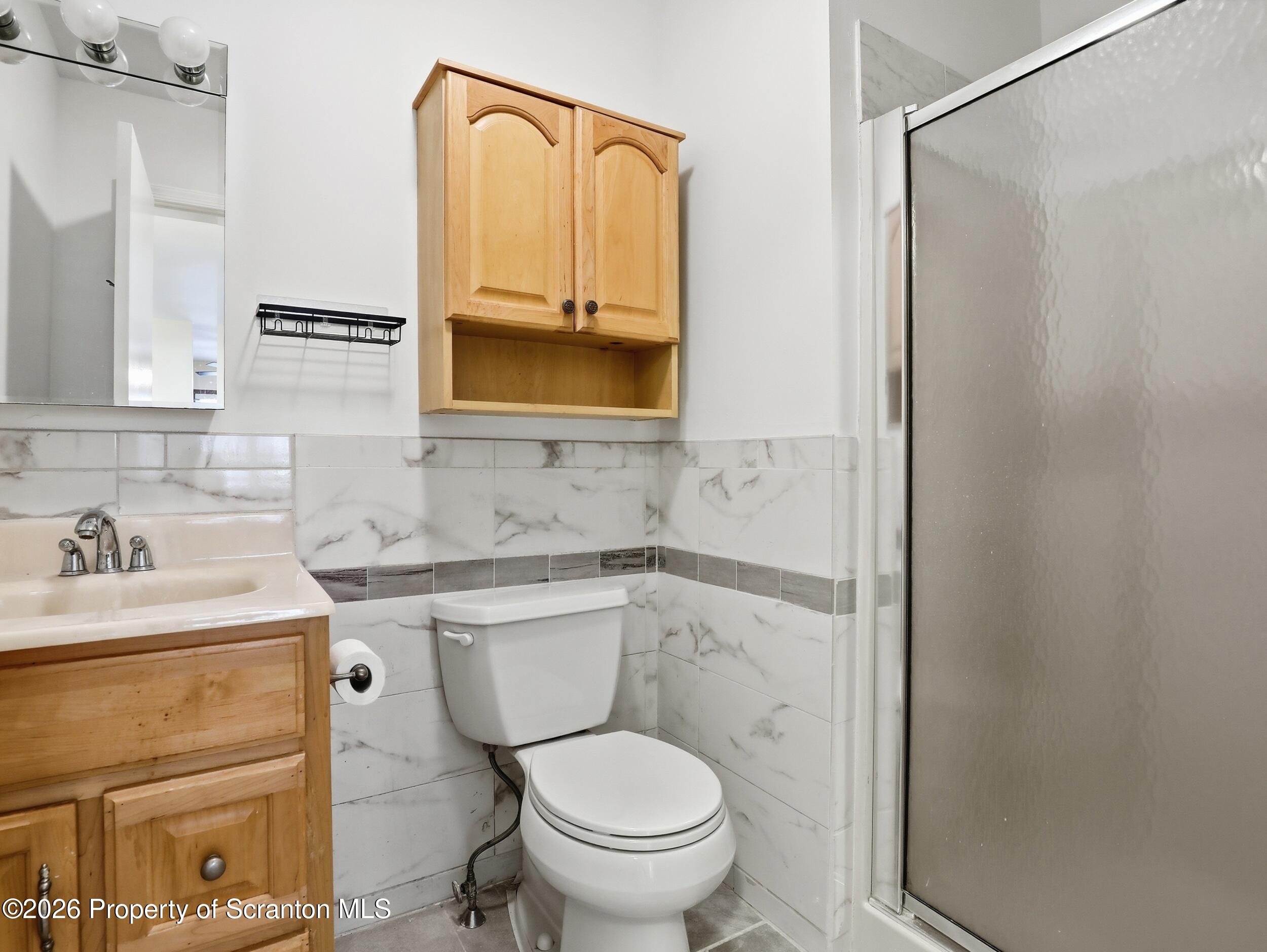 227 Image Drive Scotrun, PA 18355 - Photo 15 of 29 a bathroom with a toilet sink vanity and mirror