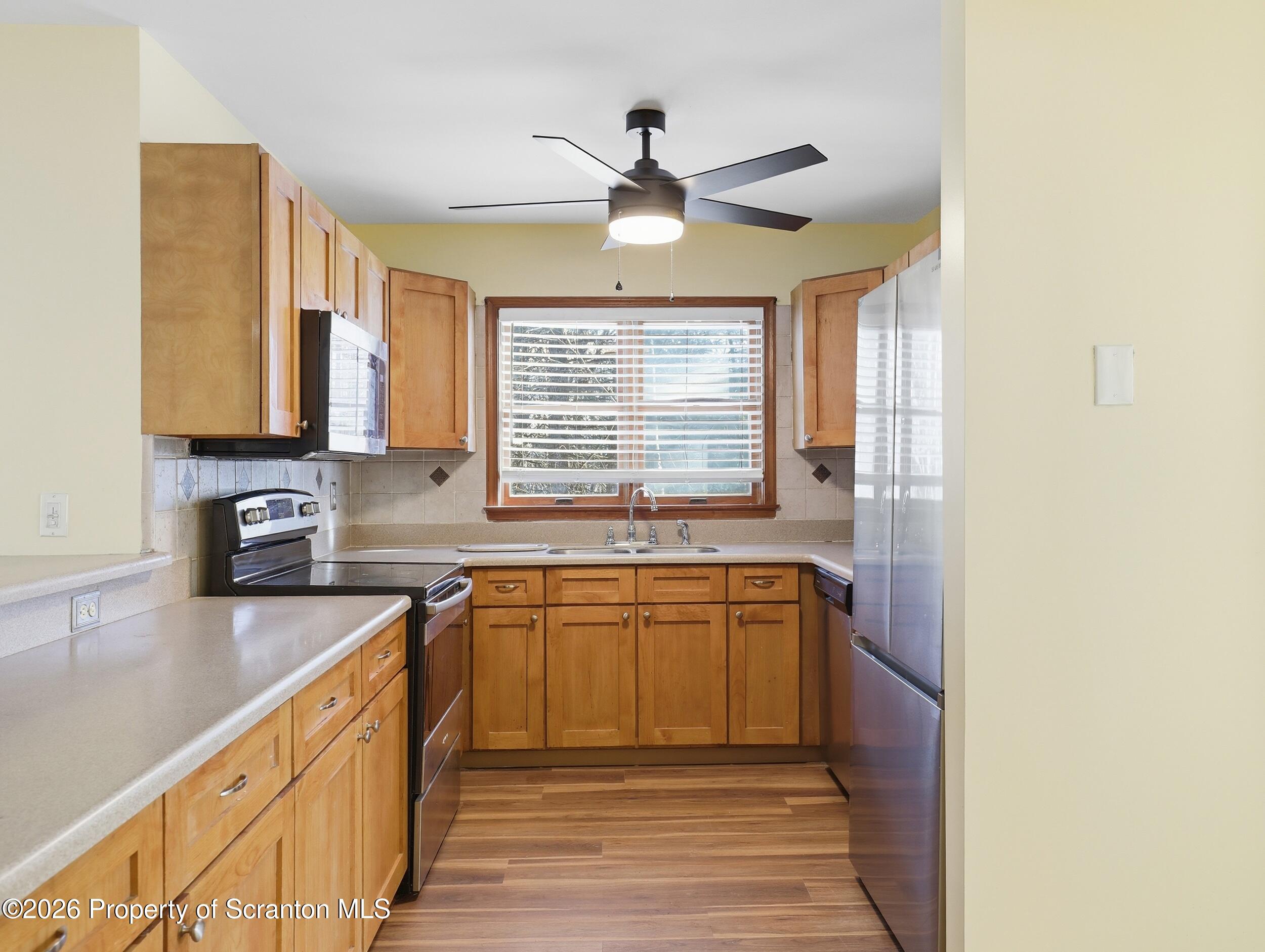 227 Image Drive Scotrun, PA 18355 - Photo 6 of 29 a kitchen with stainless steel appliances granite countertop a sink stove and cabinets