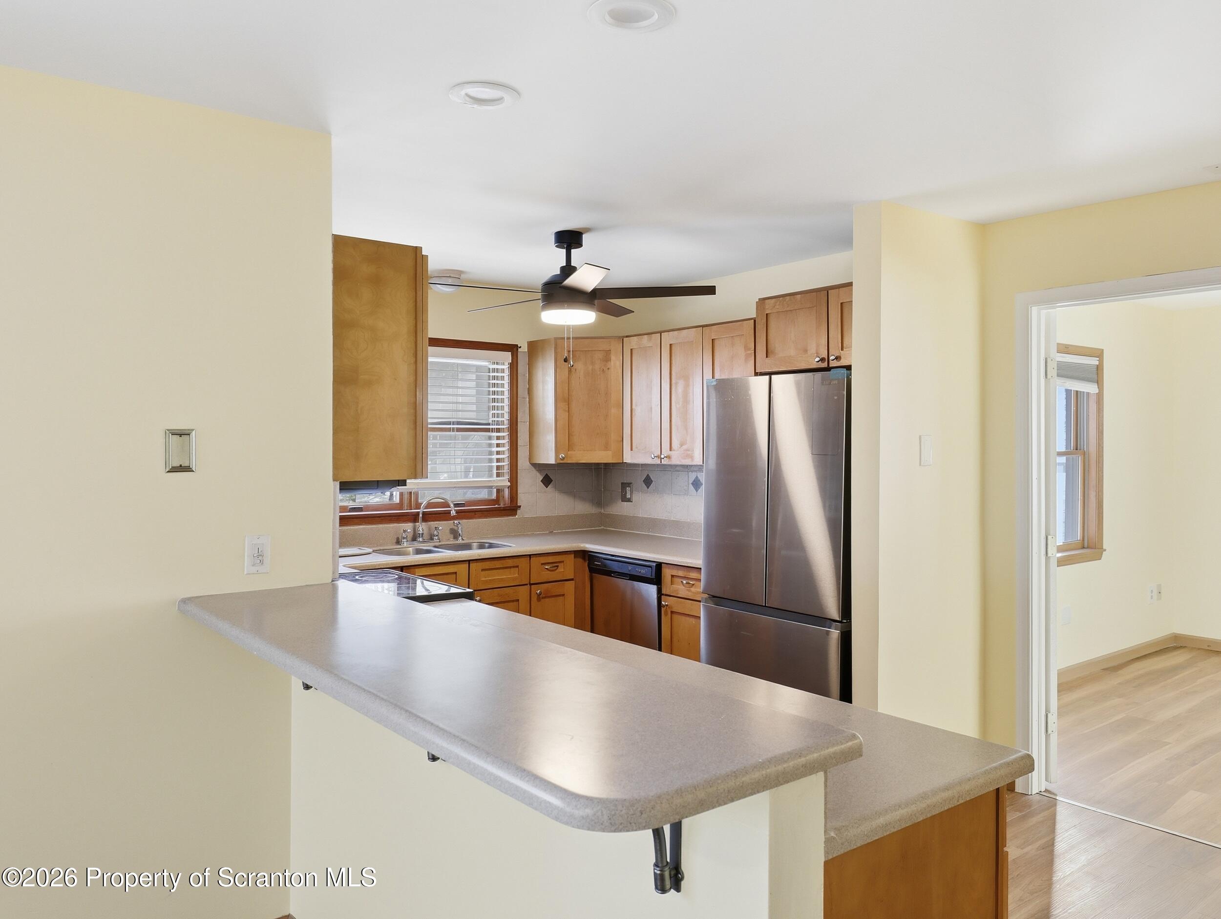 227 Image Drive Scotrun, PA 18355 - Photo 7 of 29 a kitchen with stainless steel appliances a sink and a refrigerator