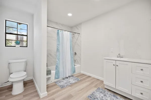 a bathroom with a toilet a sink and a window