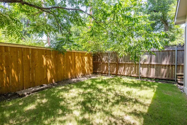 a view of yard with wooden fence