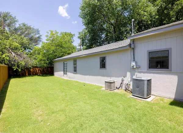 a backyard of a house with table and chairs