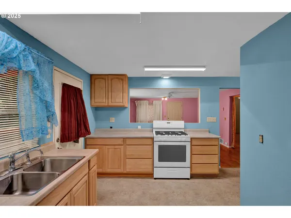 a kitchen with a sink stove and cabinets