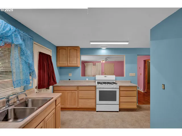 a kitchen with a sink stove and cabinets