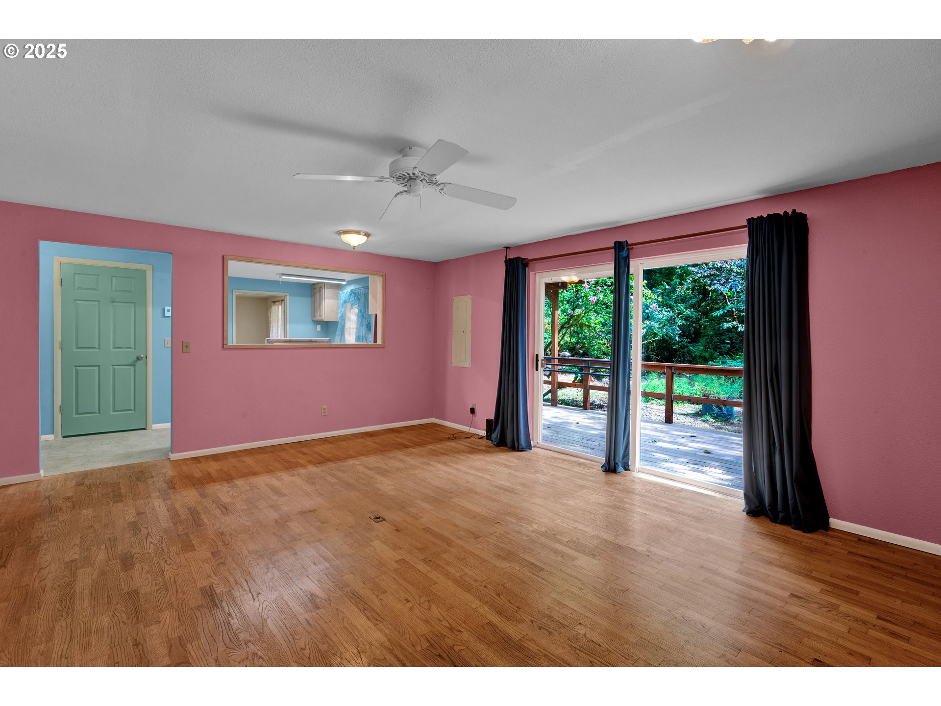 11406 East Mapleton Road Mapleton, OR 97453 - Photo 6 of 22 a view of an empty room with wooden floor and a window