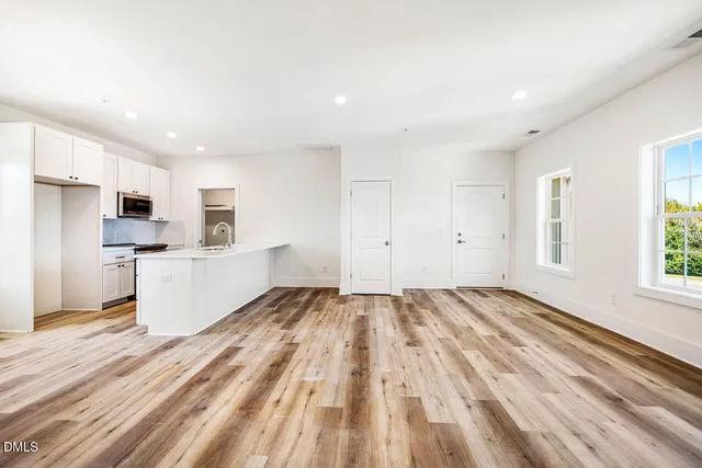 a view of kitchen with wooden floor and electronic appliances