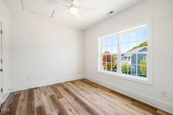 wooden floor in an empty room with a window