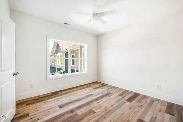 wooden floor in an empty room with a window