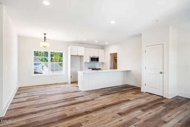 a view of kitchen with wooden floor and window